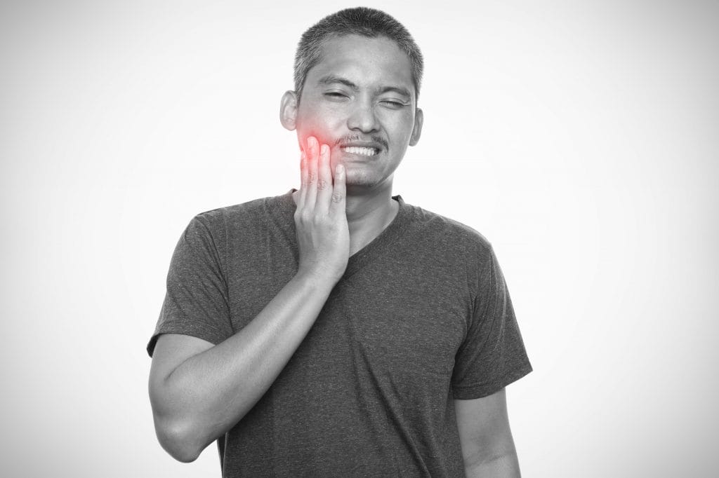 man suffering from strong toothache isolated gray background