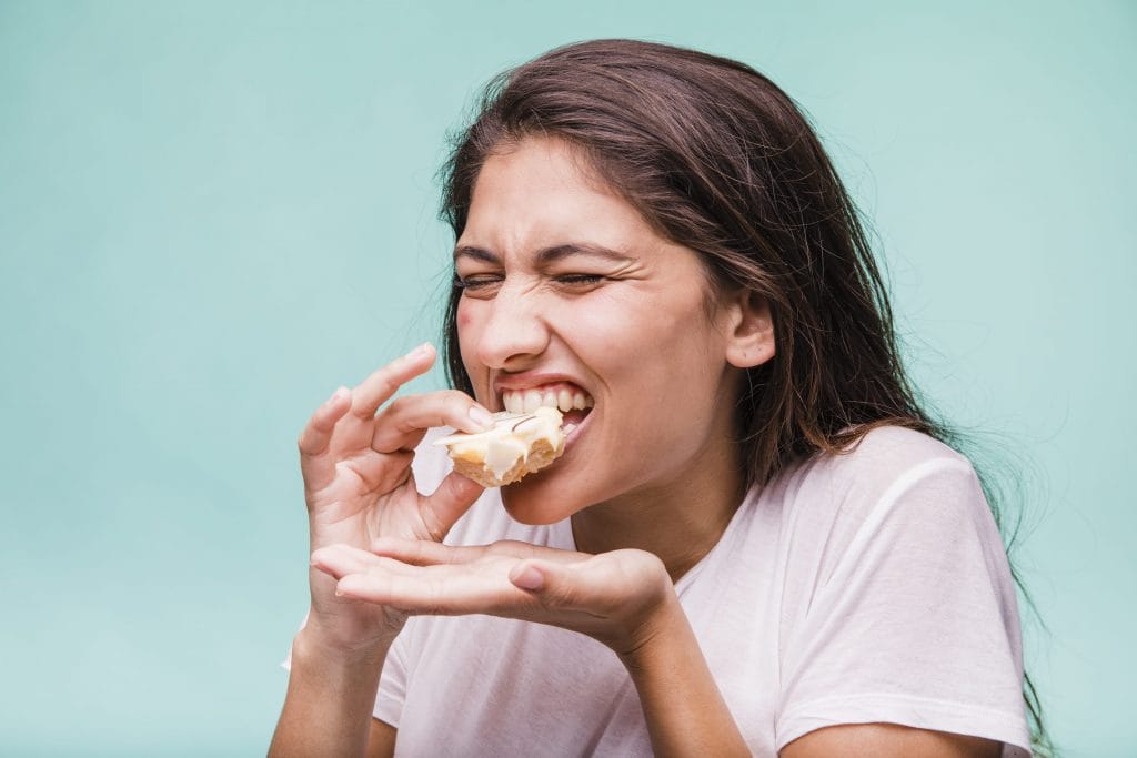 brunette girl eating pastry